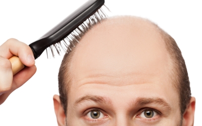 bald man brushing his remaining hair