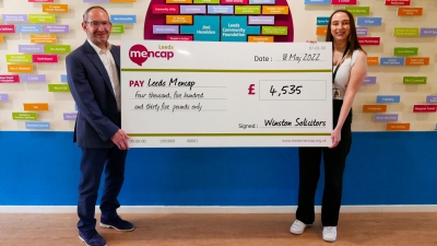 Jonathan Winston presents a fundraising cheque to Leeds Mencap