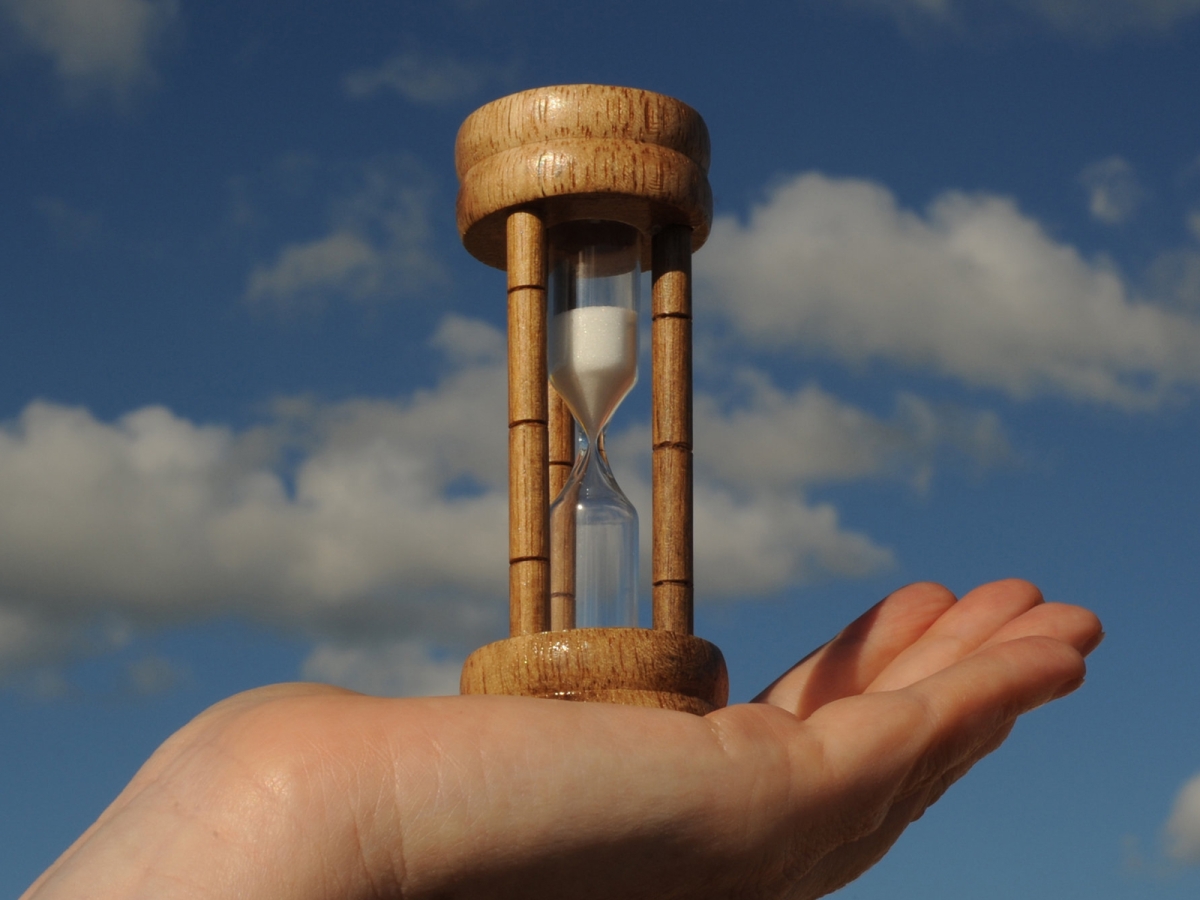 egg timer in person's hand representative of time running out