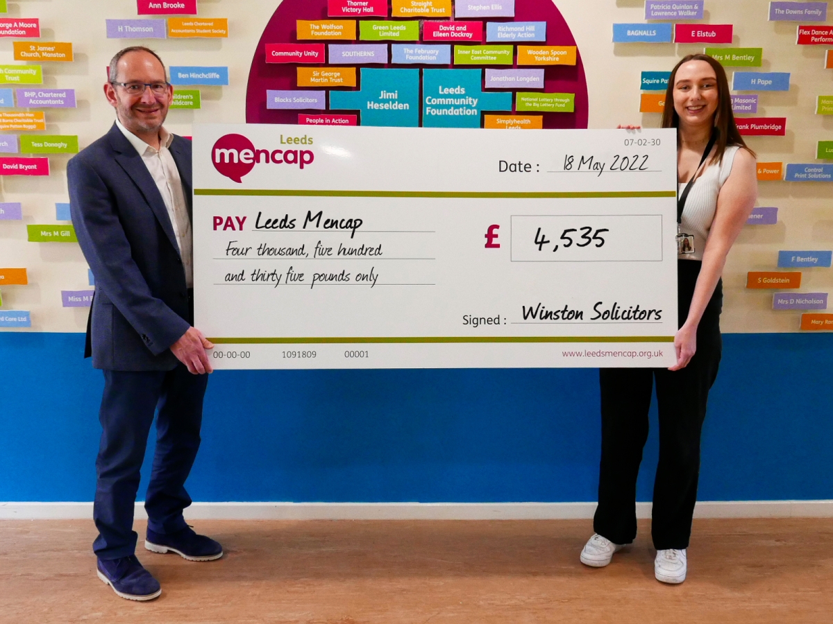 Jonathan Winston presents a fundraising cheque to Leeds Mencap